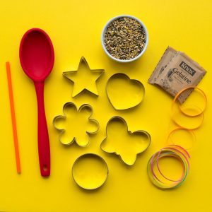 DIY seed cakes are simply to make with a few household items. You'll need bird seed, unflavored gelatin, some cookie cutters, a bit of twine and some plastic straws.